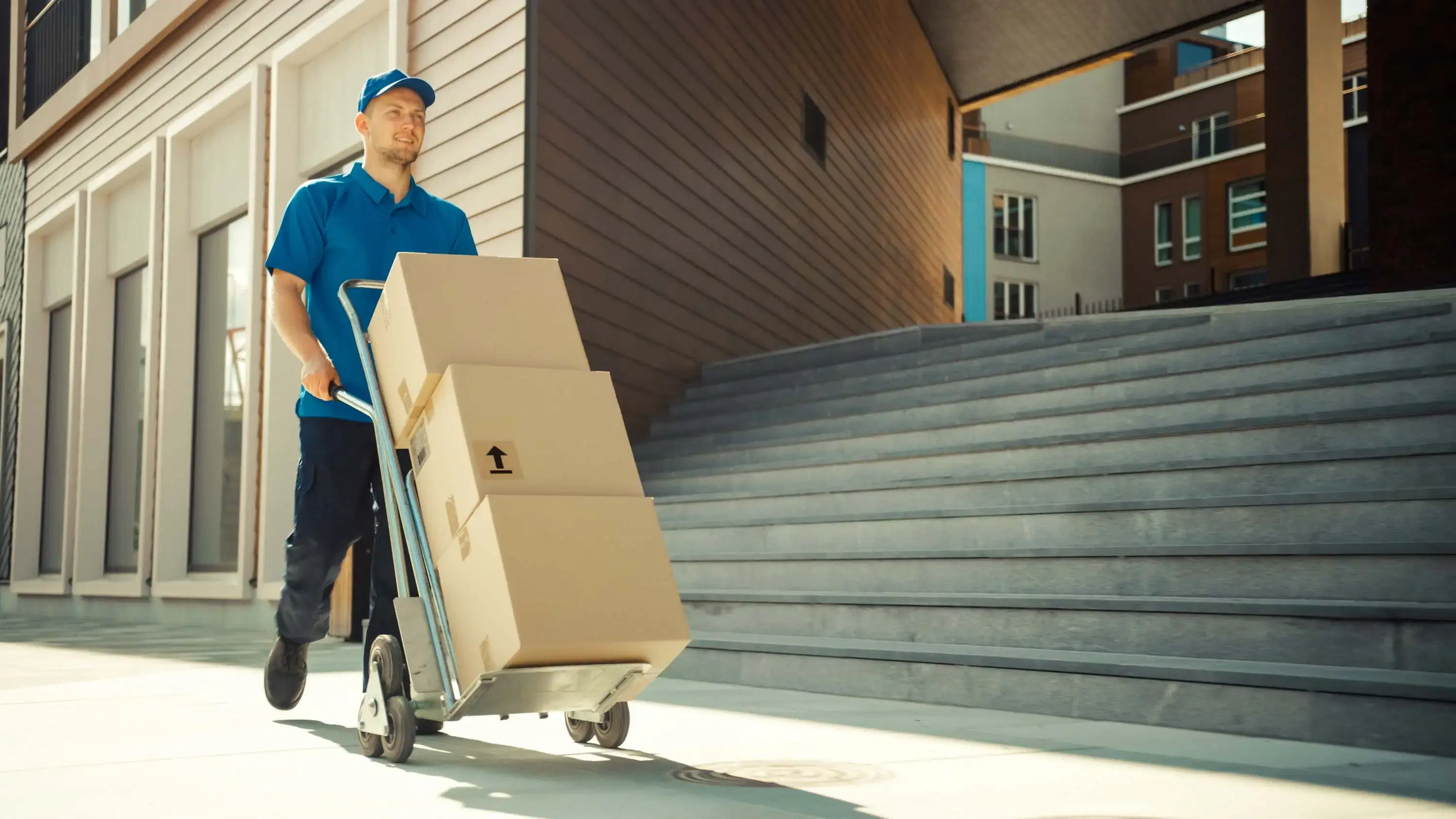 Courier transporting multiple parcels on a trolley